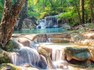 Erawan Waterfall, Thailand, Kanchanaburi, waterfall tiers, natural beauty, jungle oasis, adventure travel, serene pools, hiking trails, wildlife observation, responsible tourism, conservation efforts.